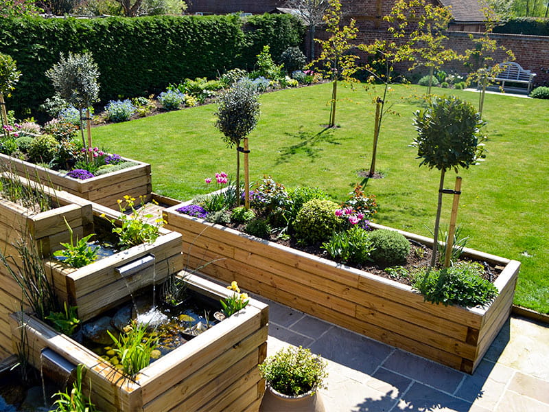 Treated Timber contemporary sleepers raised bed and pond